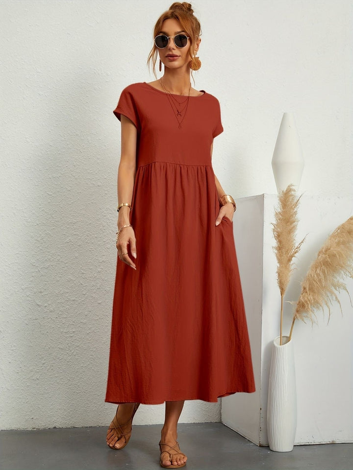 "Kimber - Midi-Relaxed Kleid mit Rundhalsausschnitt" could be rewritten as "Kimber - Midi-Relaxed Kleid mit Rundhalsdesign".