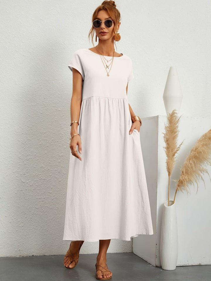 "Kimber - Midi-Relaxed Kleid mit Rundhalsausschnitt" could be rewritten as "Kimber - Midi-Relaxed Kleid mit Rundhalsdesign".